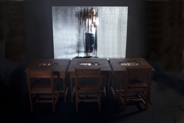 FX Harsono, Writing in the rain - installation, 2011, Installation with video performance, wooden desk & chair, acrylic sheet, 24 inch TV monitor, 180 x 250 cm | 70.87 x 98.43 in, number 1 from an edition of 3  